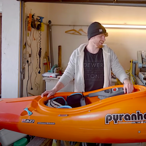 bren orton preparing his kayak for the season in the alps