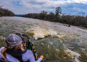 Follow Kristine Fischer and her friend Dylan on a river kayak fishing adventure, running small rapids and catching plenty of bass! Enjoy.